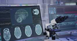 View of a microscope and brain scan images
